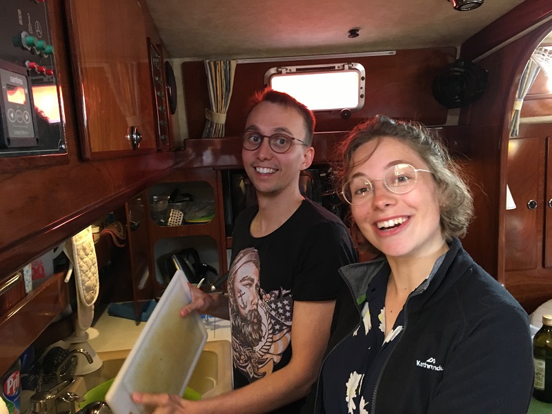 The good crew Mikkel and Lise do the dishes in Rhumb runners galley afte we have eaten their lovely dish.